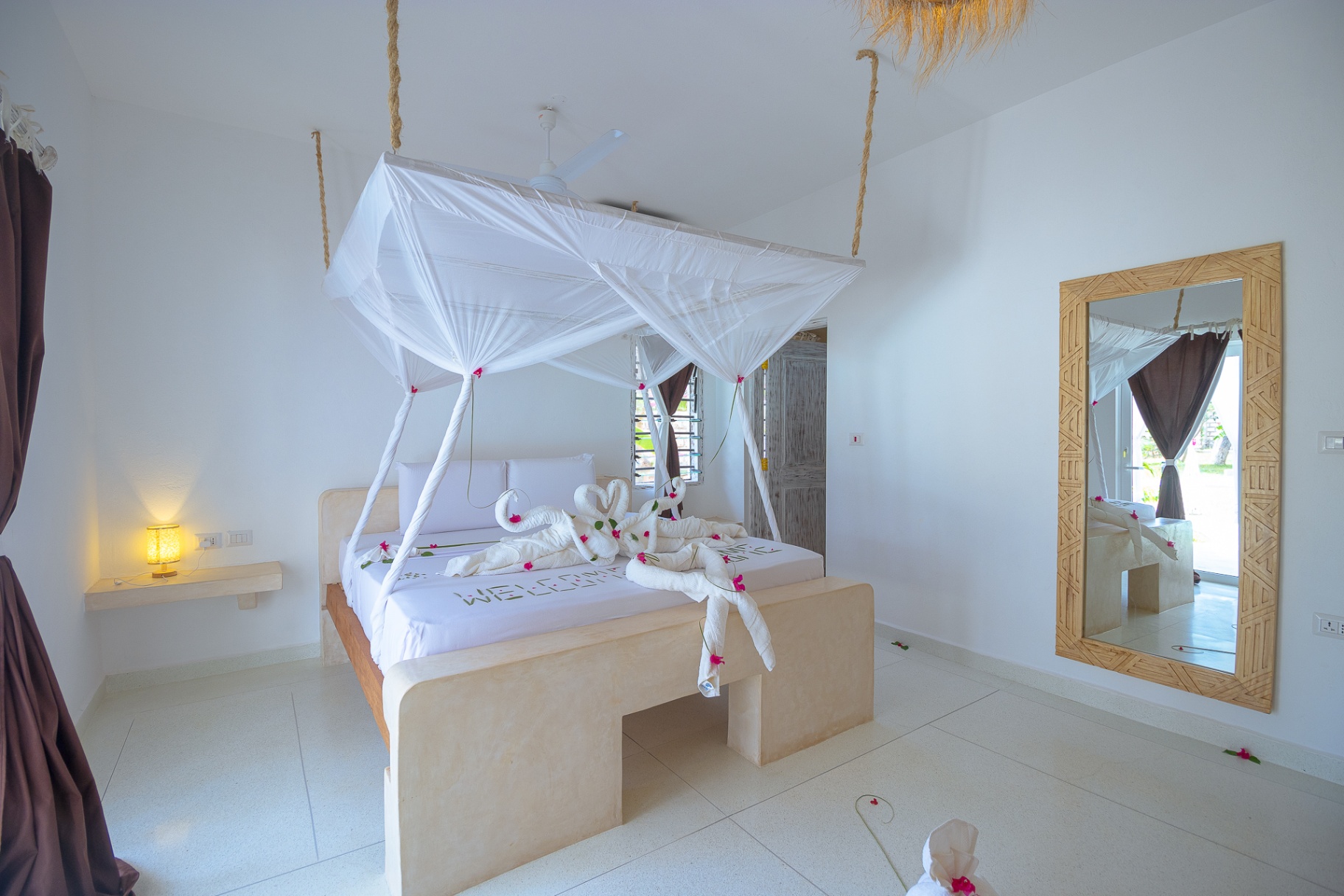 Second bedroom with hand-finished plaster and mosquito net